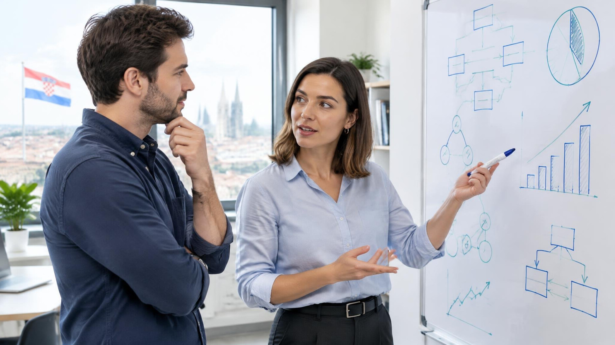 Colleagues discussing at a whiteboard